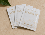 Three Goldswarm raw honey single-serve squeeze packets, 0.25 oz (7 g) each, on a stone surface